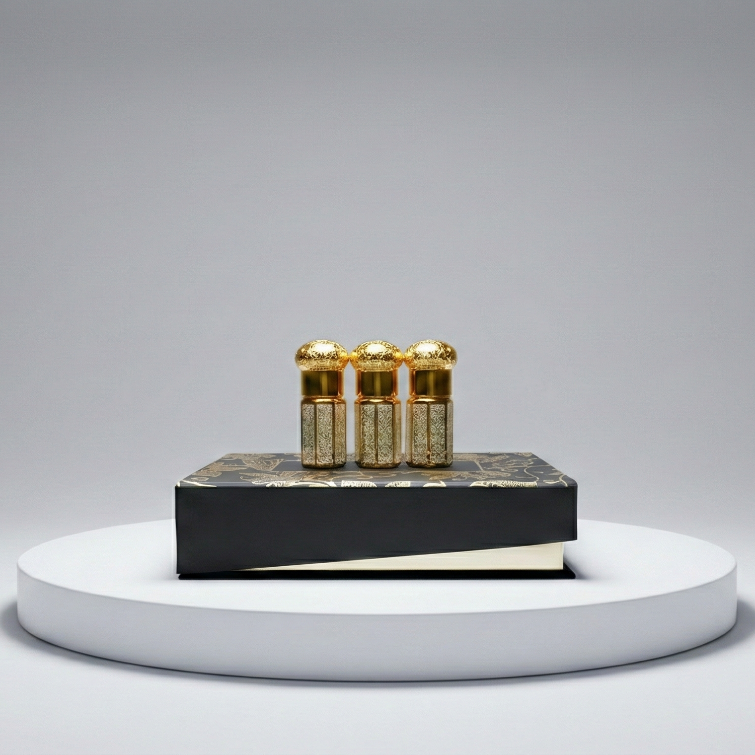 Three gold vials on a black platform with a gray background